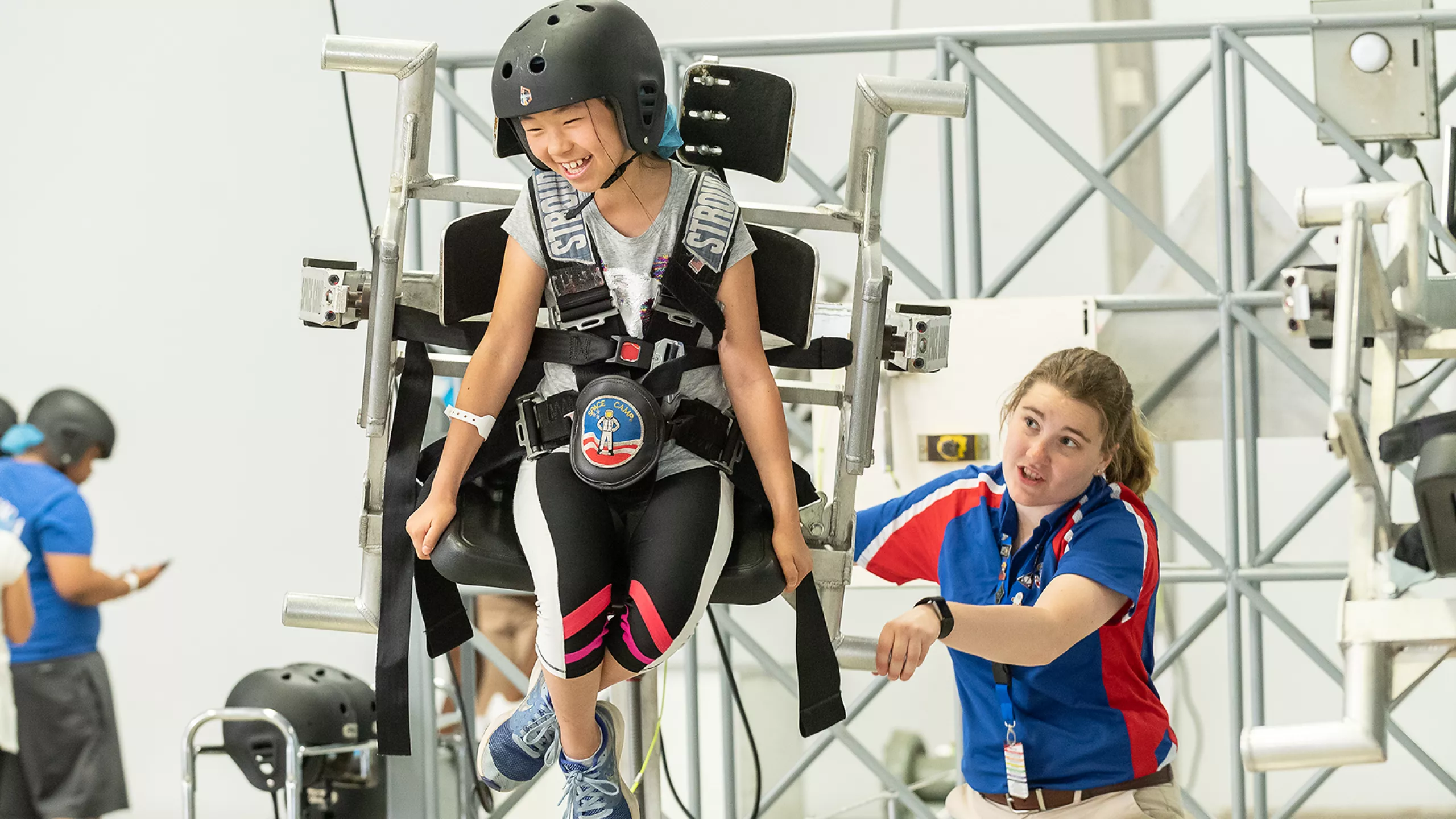 A space camp trainee experiences the five degrees of freedom in a chair that simulates movement in space.